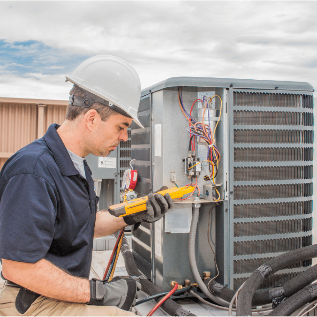 Mitchell Heating & Cooling HVAC technician servicing a system